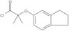 2-[(2,3-Dihydro-1H-inden-5-yl)oxy]-2-methylpropanoyl chloride