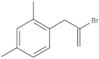 1-(2-Bromo-2-propen-1-yl)-2,4-dimethylbenzene