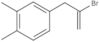 4-(2-Bromo-2-propen-1-yl)-1,2-dimethylbenzene