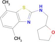 4,7-dimethyl-N-(tetrahydrofuran-2-ylmethyl)-1,3-benzothiazol-2-amine