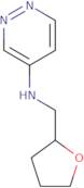 N-[(Oxolan-2-yl)methyl]pyridazin-4-amine