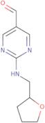 2-[(Tetrahydrofuran-2-ylmethyl)amino]pyrimidine-5-carbaldehyde