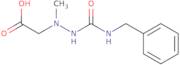 2-(2-(Benzylcarbamoyl)-1-methylhydrazinyl)acetic acid